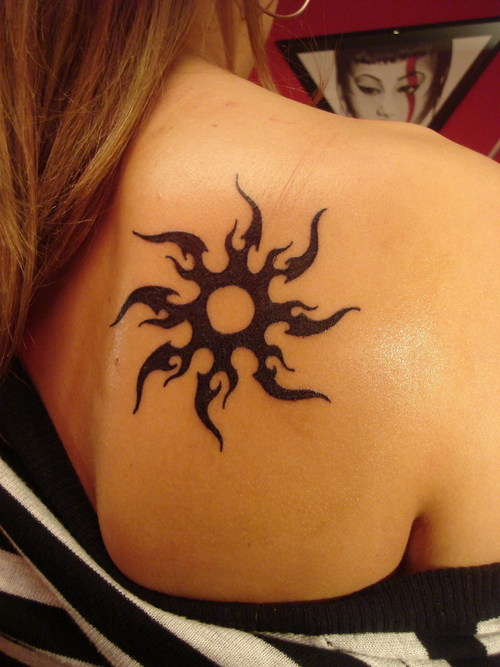 Lower back tribal Sun tattoos